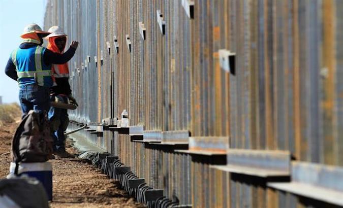 Construction workers at the wall in the town of Puerto Palomas, New Mexico, U.S., Dec. 2, 2020.