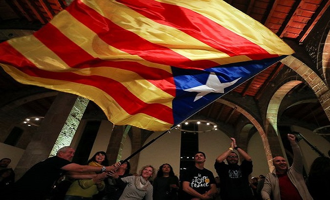 A group of people wave the Catalonia's flag, 2017.
