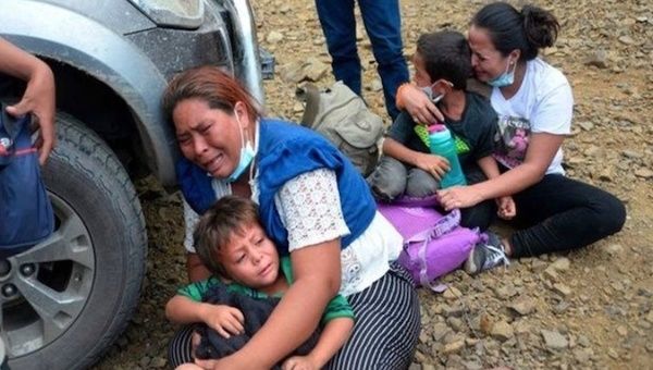 Honduran mothers and their children cry after Guatemalan police agents prevented them from crossing the border, Jan. 20, 2021.