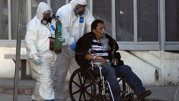 Health workers receive a COVID-19 patient, Ciudad Juarez, Mexico, Jan. 23, 2021.