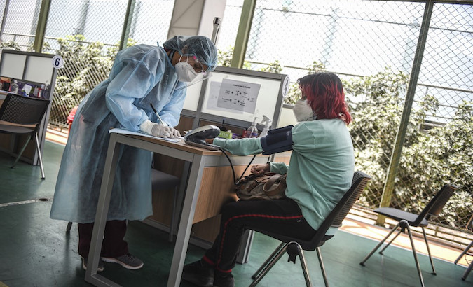 A health care worker checks a COVID-19 patient, Lima, Peru, Jan. 20, 202