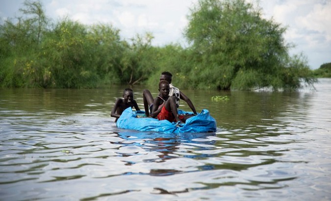 People amid a flooding, South Sudan, 2020.