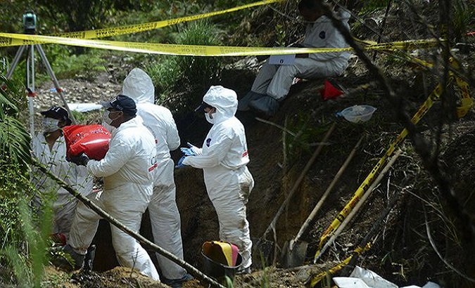 Forensic experts dig up bodies buried in mass graves, Colombia, Feb. 02, 2021.