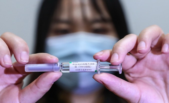 A health worker holds one dose of Sinopharm vaccine, Beijing, China. Feb. 20, 2021.