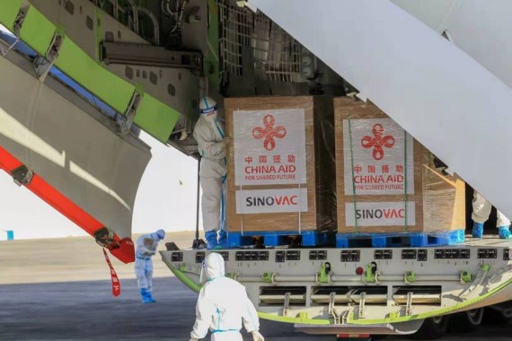 Staff members unload vaccines donated by China at a Philippine Air Force base in Manila, the Philippines on Feb. 28, 2021.