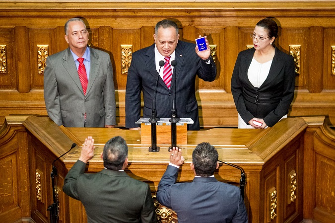 Archival image of then President of the Venezuela National Assembly (AN), Diosdado Cabello (C) holding a national constitution of Venezuela during the swearing of directives in Caracas, in 2015.