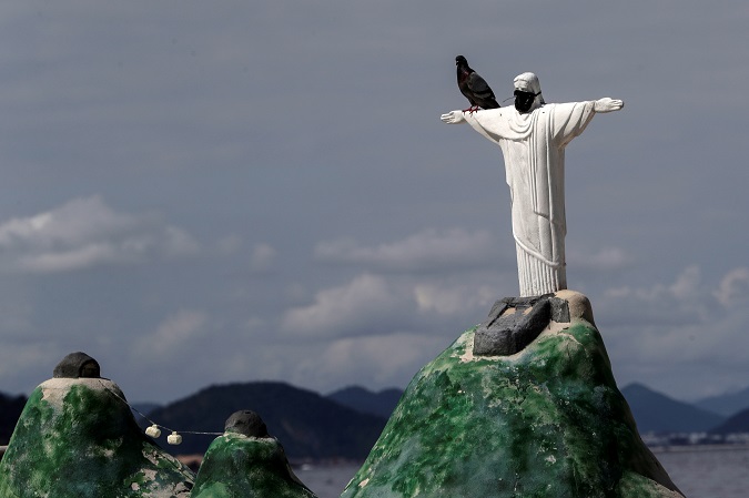 A view of a statue of Christ the Redeemer with a mask, in Rio de Janeiro. Brazil accumulates a total of 10,718,630 Covid-19 infections, with 259,271 deaths.