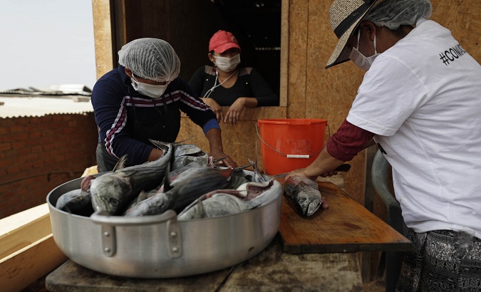 Women prepare food, Lima, Peru, Feb. 3, 2021.