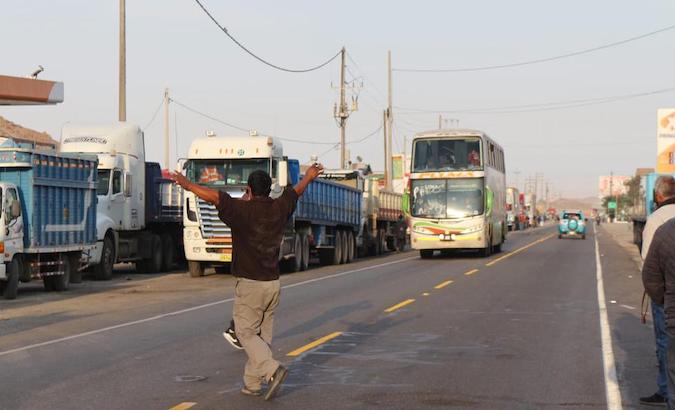 A truck driver crosses the Pan-American Highway in Arequipa, Peru, March 16, 2021.