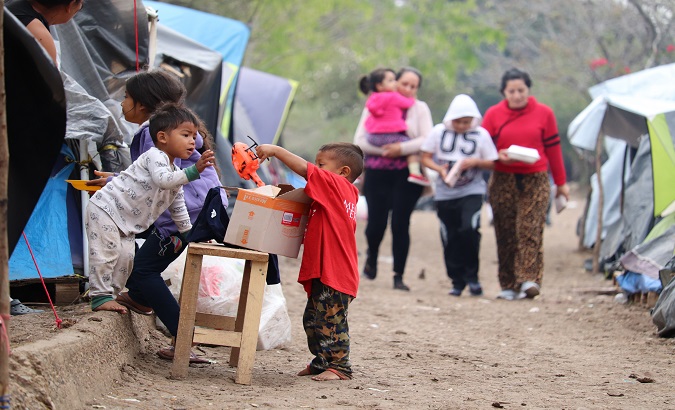 Children play in a migrant camp near the Rio Grande river, Mexico, Jan. 31, 2021.