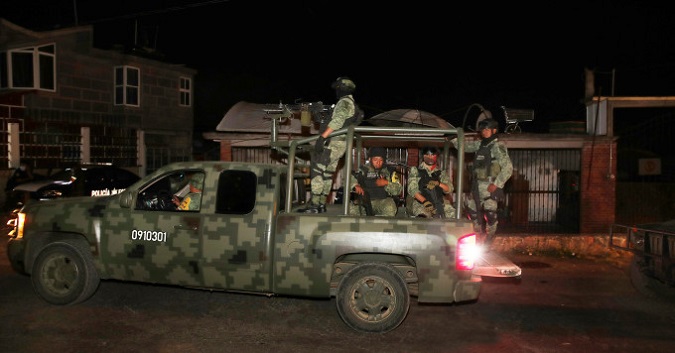 Gunmen apparently from a drug gang ambushed a police convoy Thursday in central Mexico, killing eight state police officers and five prosecution investigators in a hail of gunfire.