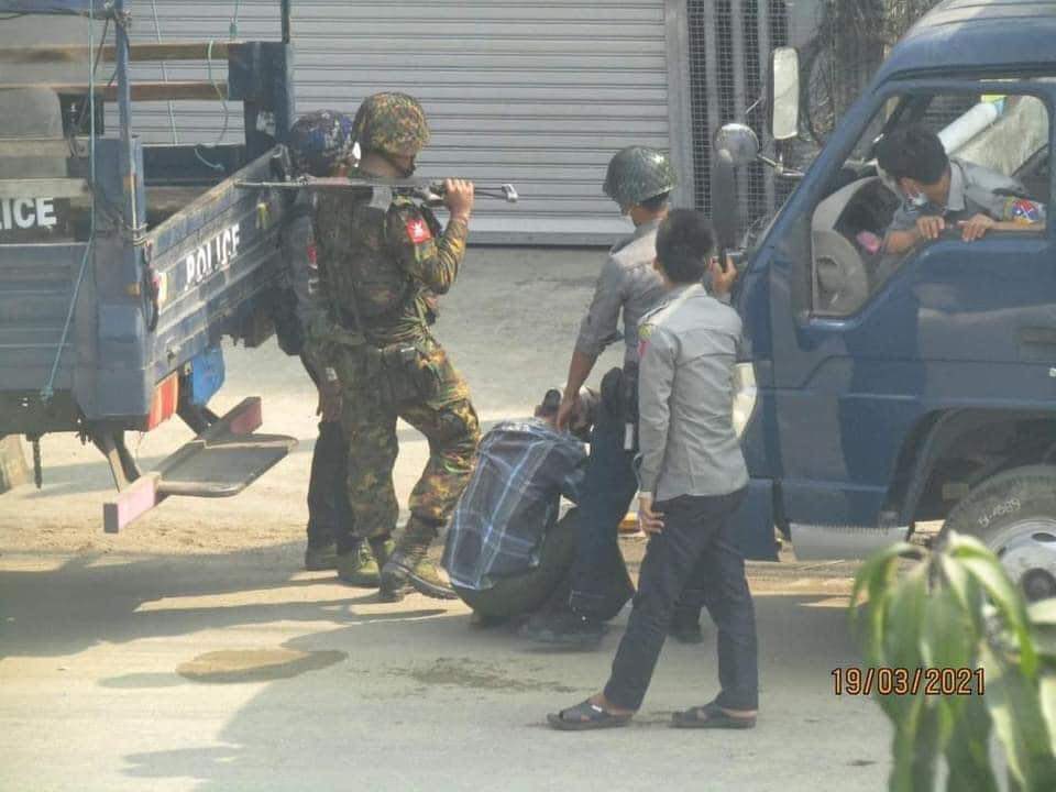 Police members torture a civilian in the central town of Aungban on March 19, 2021.