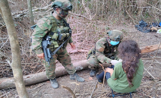 Soldiers assist a girl who survived an airstrike, Colombia, 2021.