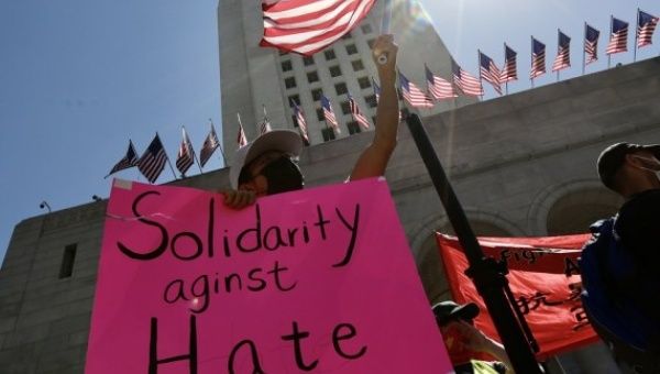 People participate in a Stop Asian Hate rally and march in response to the rising violence against Asian American communities at Los Angeles City Hall, California, the United States March 27, 2021.