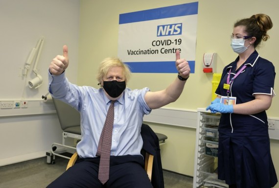 British Prime Minister Boris Johnson (L) thumbs up after receiving the Oxford-AstraZeneca COVID-19 vaccine at St Thomas' Hospital in London, Britain, March 19, 2021.