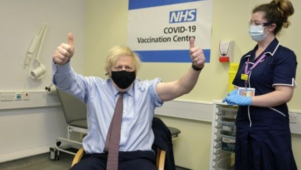 British Prime Minister Boris Johnson (L) thumbs up after receiving the Oxford-AstraZeneca COVID-19 vaccine at St Thomas' Hospital in London, Britain, March 19, 2021.