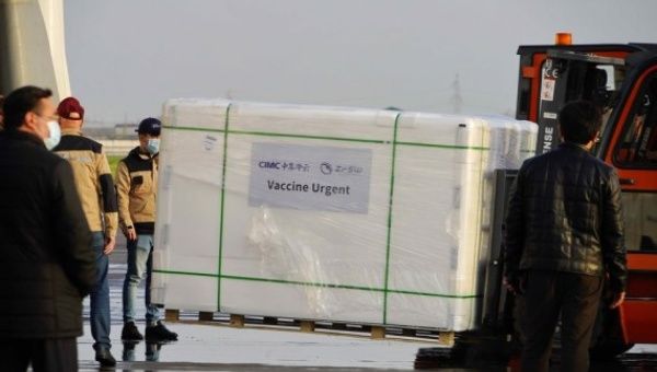 Workers transfer COVID-19 vaccines at Tashkent International Airport in Tashkent, Uzbekistan, on March 27, 2021.