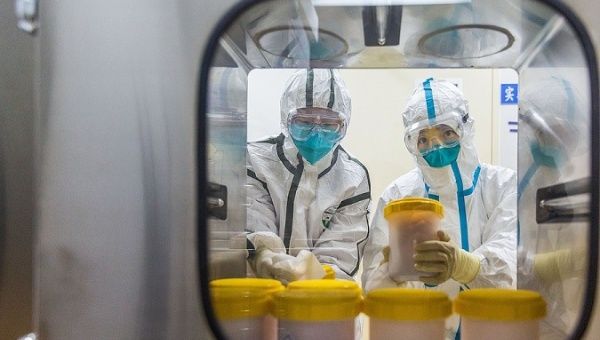 Scientists receive samples transported from Zhejiang Provincial Center for Disease Control, Beijing, China, Feb. 25, 2020.