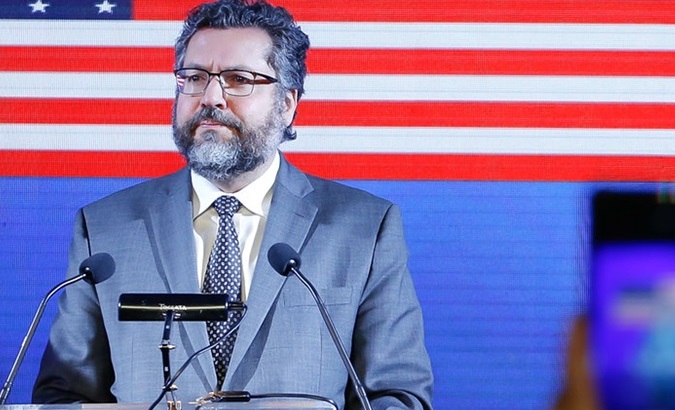 Brazil's ex-Foreign Affairs Minister Ernesto Araujo in front of a U.S. flag.