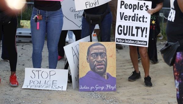 People react near a mural of George Floyd after former Minneapolis Police Department Police Officer Derek Chauvin was found guilty on all counts in Minneapolis, Minnesota in the death of Floyd in Atlanta, Georgia, USA,