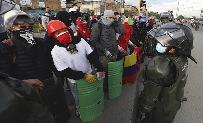 Citizens protest in front of police officers, Bogota, Colombia, May 2021.