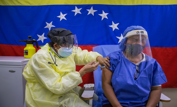 A nurse applies a COVID-19 vaccine dose, Caracas, Venezuela, March  26, 2021.