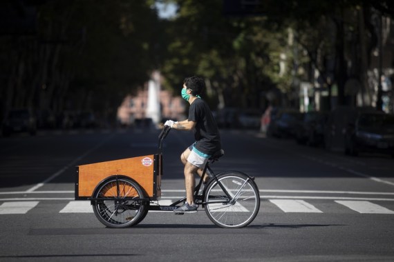 A delivery man wearing a face mask rides along a street in Buenos Aires, Argentina, April 8, 2020.
