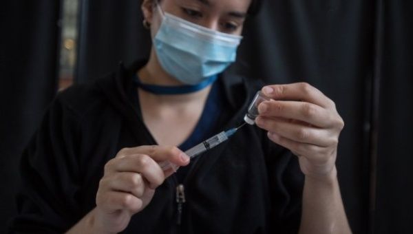 A nurse prepares a dose of COVID-19 vaccine at a vaccination site in Santiago, Chile, March 25, 2021.