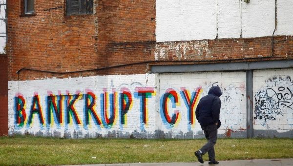 A man walk past graffiti in Detroit, Michigan in this file photo taken December 3, 2013. (Reuters)