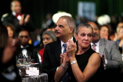 U.S. Attorney General Eric Holder (C) and his wife Sharon Malone (R) attend the Congressional Black Caucus Foundation dinner in Washington September 27 (Reuters)