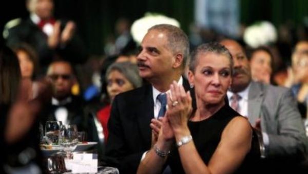 U.S. Attorney General Eric Holder (C) and his wife Sharon Malone (R) attend the Congressional Black Caucus Foundation dinner in Washington September 27 (Reuters)