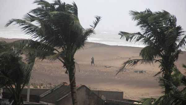 A man walks as strong winds blow along a beach in Gopalpur in Ganjam district in the eastern Indian state of Odisha October 12, 2014.  (Photo: Reuters)