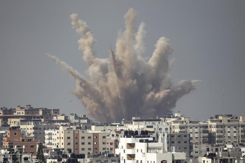 Smoke and sand are seen following what witnesses said was an Israeli airstrike in Gaza Aug. 25, 2014.