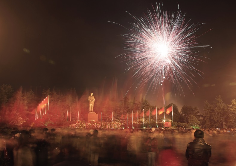 Fireworks explode above a square as nearly 100,000 people gather to celebrate the 121th birth anniversary of China's former Communist Party leader Mao Zedong in his hometown of Shaoshan, Hunan province, Dec. 26, 2014.