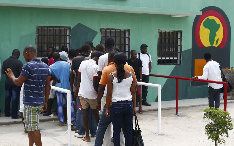 Fans wait in line to buy tickets for the upcoming African Nations Cup outside the Estadio de Bata 