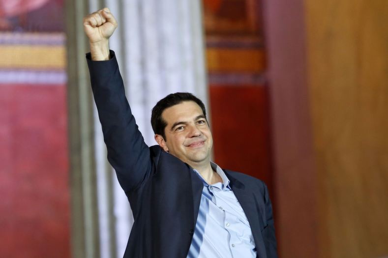 The head of radical leftist Syriza party Alexis Tsipras raises his fist to supporters after winning the elections in Athens January 25, 2015
