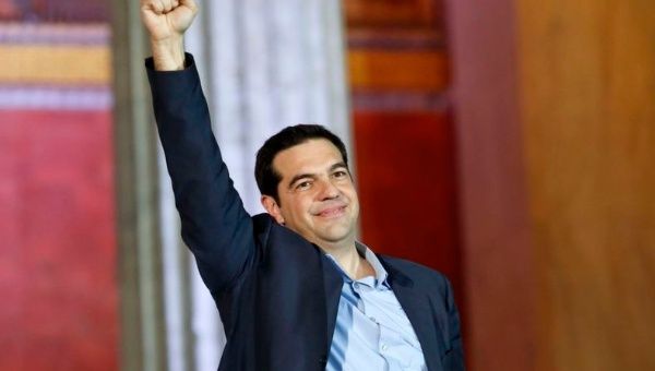 The head of radical leftist Syriza party Alexis Tsipras raises his fist to supporters after winning the elections in Athens January 25, 2015