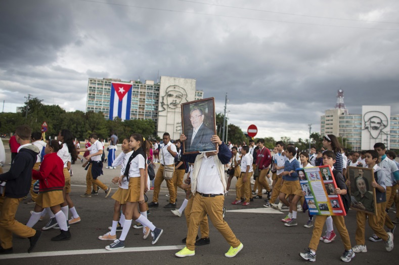A student carries a photograph of Cuba's President Raul Castro near the memorial of Jose Marti on Revolution Square in Havana on January 28, 2015