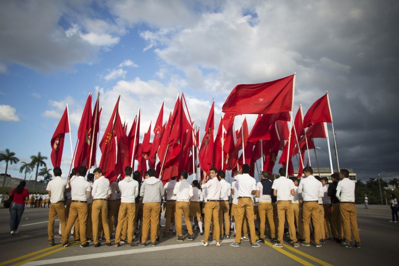 Students carry flags of Jose Marti Pioneers Organization near the memorial of Jose Marti on Revolution Square in Havana on January 28, 2015