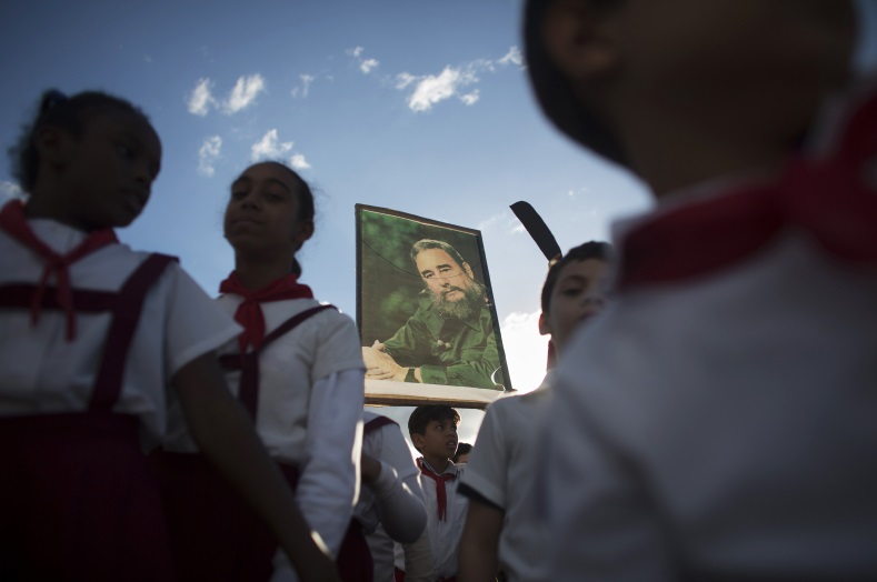 A student holds up a photograph of Cuba's former President Fidel Castro at the memorial of Jose Marti on Revolution Square in Havana on January 28, 2015