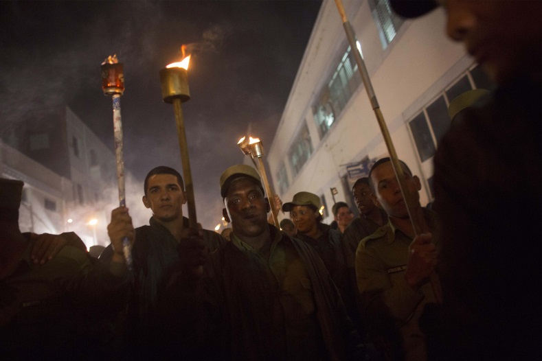 Soldiers hold torches during a march in celebration of the 162nd birth anniversary of Cuba's independence hero Jose Marti in Havana on January 27, 2015