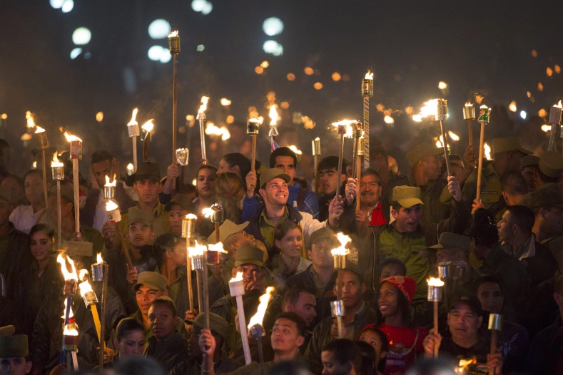 Cuban soldiers hold torches during a march in celebration of the 162nd birth anniversary of Cuba's independence hero Jose Marti, in Havana on January 27, 2015