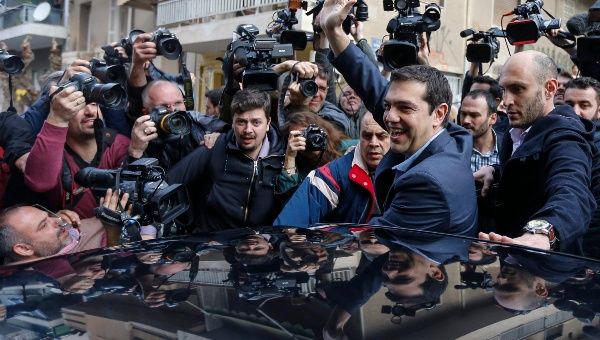 Greece's new Prime Minister Alexis Tsipras of Syriza waves as he leaves a polling station in Athens Jan. 25, 2015.