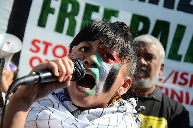 Jollene Levid speaks at 2014 Palestine solidarity rally. Palestinian resistance is a source of inspiration for her own feminist struggle.