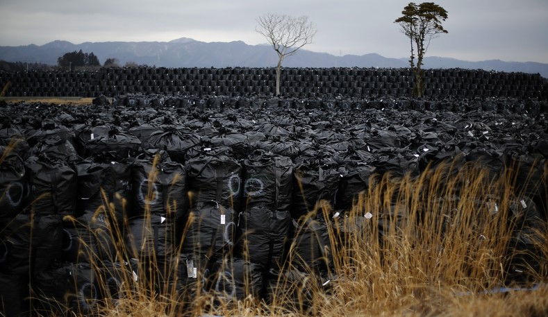 Big black plastic bags containing radiated soil, leaves and debris from the decontamination operation are dumped at a temporary storage site in Tomioka town, Fukushima prefecture, near Tokyo Electric Power Co's (TEPCO) tsunami-crippled Fukushima Daiichi nuclear power plant Feb. 22, 2015. 