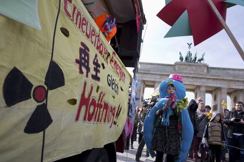 People protest against the use of nuclear energy and atomic bombs during a demonstration marking the 4th anniversary of the Fukushima nuclear catastrophe, in front of the Brandenburg Gate in Berlin, March 7, 2015.