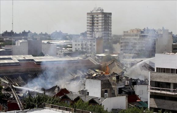 Firefighters work to put out a blaze at an Iron Mountain warehouse in the Barracas neighborhood of Buenos Aires, Argentina.