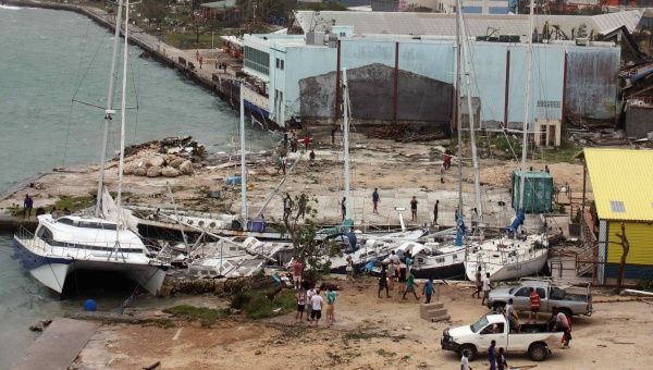 Local residents look at damaged boats washed up into a small inlet in Port Vila, the capital city of the Pacific island nation of Vanuatu, March 14, 2015. 