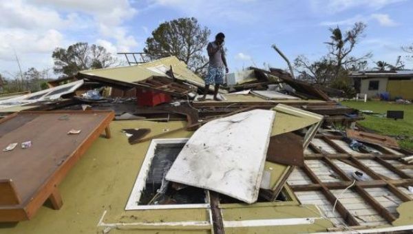 A local resident looks at his home destroyed by Cyclone Pam in Port Vila, the capital city of Vanuatu March 16, 2015. 