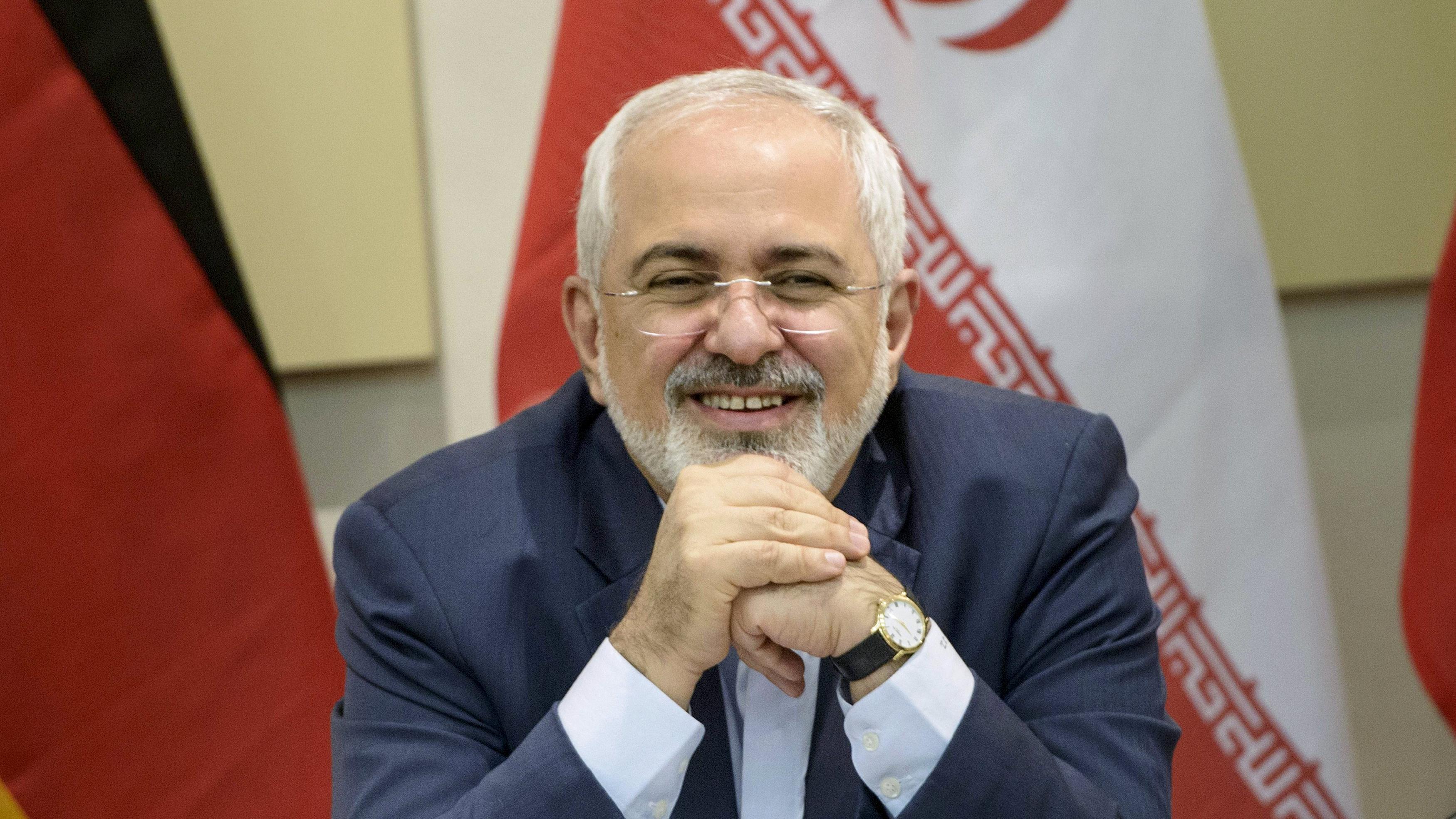 Iranian Foreign Minister Javad Zarif smiles as he waits for the start of a meeting with P5+1, European Union and Iranian officials at the Beau Rivage Palace Hotel in Lausanne March 30, 2015, during Iran nuclear talks.